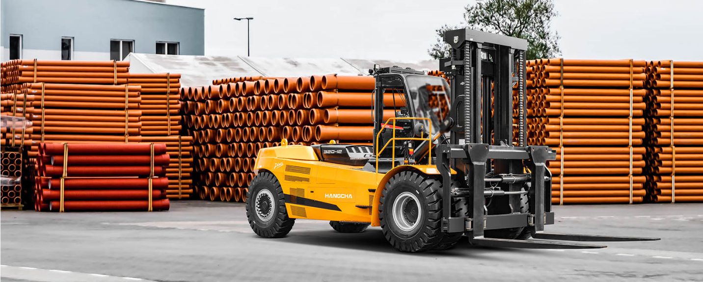 Forklift driving through a yard full of copper pipes